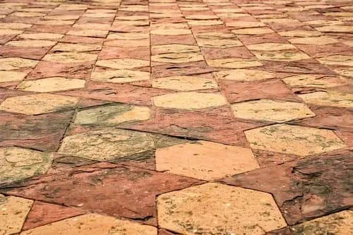Stamped concrete walkway finished in a warm tumbled-stone pattern and integral color